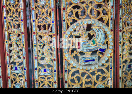 Patterns of golden craving swan and angels on the old wall Stock Photo