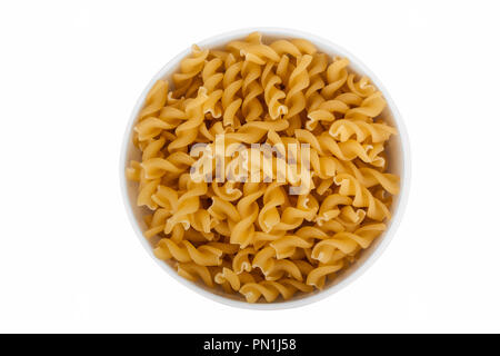 Fusilli pasta in bowl isolated on white background Stock Photo