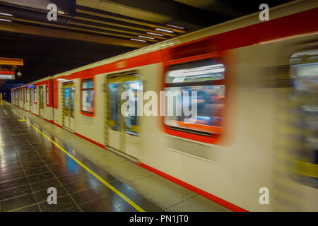 SANTIAGO, CHILE - SEPTEMBER 14, 2018: Indoor view of blurred metro in the rails inside of the Estacion Alameda, central station. Opened in 1885, now it is the city's only railway station Stock Photo