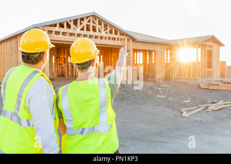 Male and Female Construction Workers at New Home Site. Stock Photo