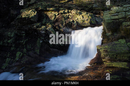 Long exposure of a small waterfall stuck between the rocks. Stock Photo