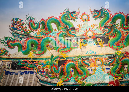 Colorful chinese dragon statues on roof in Chinese temple. Chinese dragons on the roof top of shrine. Stock Photo