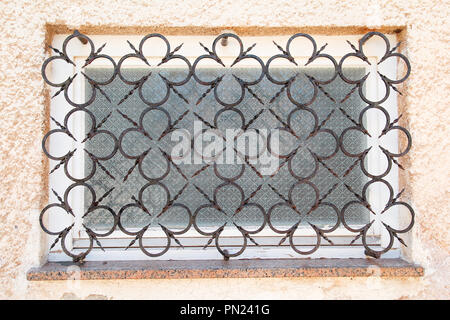 Old house window style with curved steel, decorative iron gratings with decorative details. Abstract decorative metal protection for windows. Stock Photo