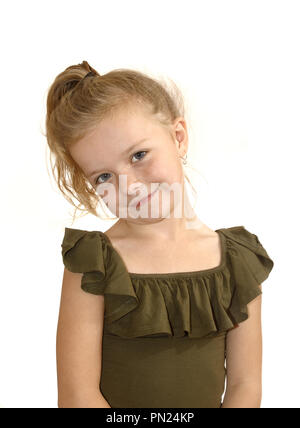 Girl, with head tilted, smiling at camera Stock Photo