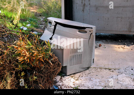 Discard old TV sets on a street, television near the garbage container thrown, natural environment. A TV thrown out with the garbage. Throwing out Stock Photo