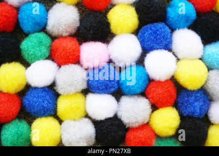Flat lay many colorful fluffy wool pom poms background Stock Photo