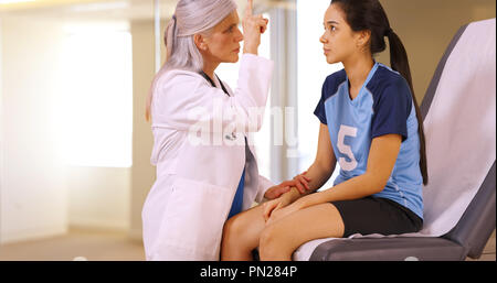 An injured soccer player seeks medical attention in an emergency room Stock Photo