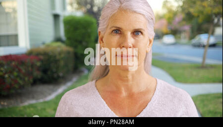 An older woman in her suburban neighborhood Stock Photo