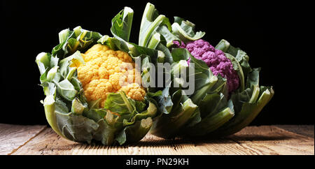 Colorful cauliflower cabbages on table. Healthy food Stock Photo