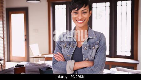 Happy smiling woman homeowner standing in living room Stock Photo