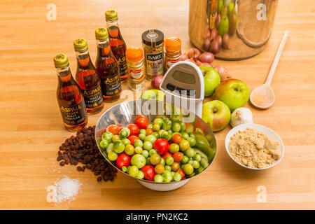 End of season tomatoes and ingredients for making home made green tomato and apple chutney, pickle. Stock Photo