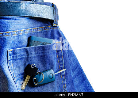 Jeans on white background. smartphone in your pocket. on top of the keys to the car Stock Photo