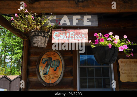 POLEBRIDGE, MONTANA, USA - September 9, 2018: Cafe, Cold Beer and vintage 7Up signs adorn the exterior of the Northern Lights Saloon. Stock Photo