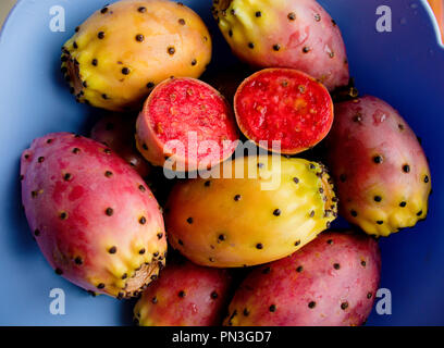 Prickly pear cactus colorful fresh ripe whole and cut fruits in bowl. Opuntia fichi d'india. South Italy. Top view. Close up. Food background Stock Photo