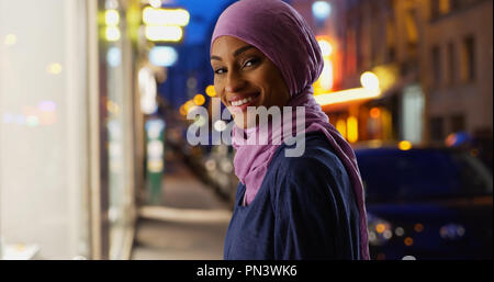 Beautiful young Muslim woman in urban setting smiling at camera Stock Photo