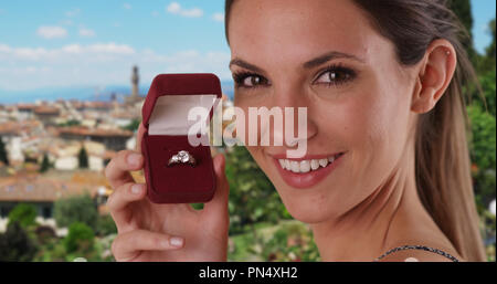 Happy millennial girl showing off engagement ring while in Florence Italy Stock Photo