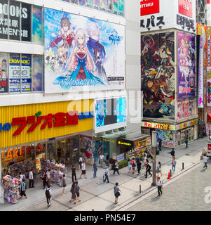 A view of tourists, anime bookshops and signs in the Akihabara district of Tokyo, Japan. Stock Photo