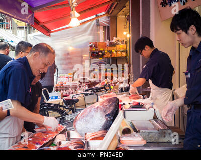 Fish mongers work with tuna at the Tsukiji Fish Market (Tsukiji outer market) in Tsukiji, Tokyo, Japan. Stock Photo