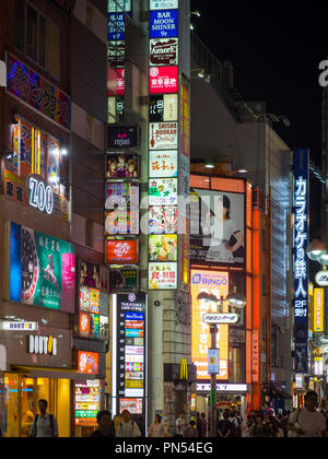 Lit signs and neon signs at night on a busy alley between Shibuya Center-Gai and Shibuya Bunkamura-dori in Shibuya City, Tokyo, Japan. Stock Photo