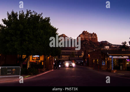 Phoenix, ARIZONA - October 21 2017: Night scene in the city of Sedona. Cars and shops in the foreground and a view of the mountains in the background Stock Photo