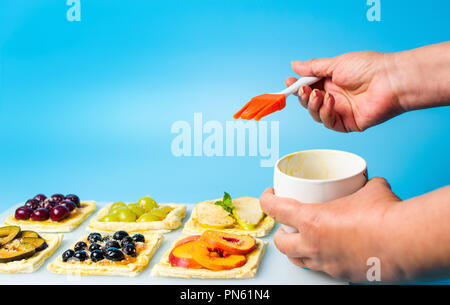 Chef applying egg on the fruit sweet pie before baking Stock Photo