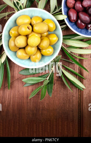 Overhead photo of various olives in bowls with a place for text Stock Photo