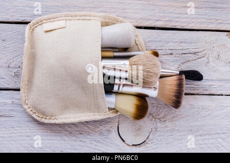 A set of various make-up brushes in a cosmetic bag. Flat lie. Stock Photo