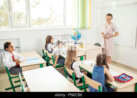 female teacher teaching group of teenagers in high school lesson Stock Photo