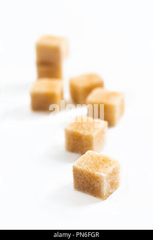 Food Spot focus organic Brown sugar cane cubes on white background Stock Photo