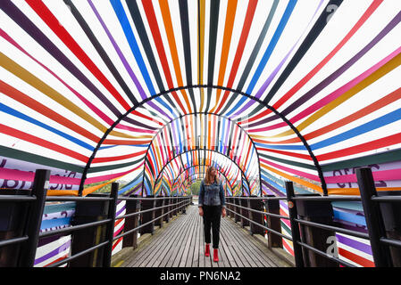 London, UK.  20 September 2018. A woman walks through 'Gateway to Inclusion', an installation conceived by Lisa White, Head of Lifestyle and Interiors at WGSN, with designer François Dumas, a structure made of steel and ribbon, two of the city of Saint Etienne’s traditional industries on display during designjunction, part of London Design Festival, on the South Bank.  Now in its eighth year, hundreds of product launches, boutique pop-up shops, bespoke installations, exhibitions, and a specially curated talks programme will take place 20-23 September.  Credit: Stephen Chung /Alamy Live News Stock Photo