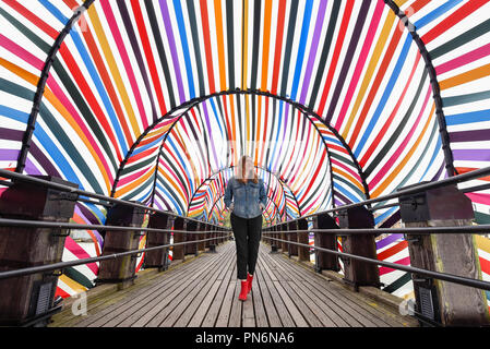 London, UK.  20 September 2018. A woman walks through 'Gateway to Inclusion', an installation conceived by Lisa White, Head of Lifestyle and Interiors at WGSN, with designer François Dumas, a structure made of steel and ribbon, two of the city of Saint Etienne’s traditional industries on display during designjunction, part of London Design Festival, on the South Bank.  Now in its eighth year, hundreds of product launches, boutique pop-up shops, bespoke installations, exhibitions, and a specially curated talks programme will take place 20-23 September.  Credit: Stephen Chung /Alamy Live News Stock Photo