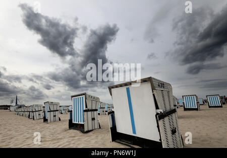 20 September 2018, Mecklenburg-Western Pomerania, Warnemünde: Above the beach chairs in Warnemünde clouds are rising. In the coming days clouds, wind and colder temperatures will dominate the weather. Photo: Bernd Wüstneck/dpa-Zentralbild/dpa Stock Photo