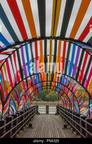 London, UK. 20th September 2018. The london skyline and art installations at design junction, part of the london design festival on the south bank of the river thames in central london at the Oxo tower. The colourful 'gateway to inclusion' and the wooden sculpture 'head above water raising the profile of mental health issues in the UK. A typical autumn morning with grey clouds over the city of London provides the backdrop and skyline in an atmospheric London landscape. Stock Photo