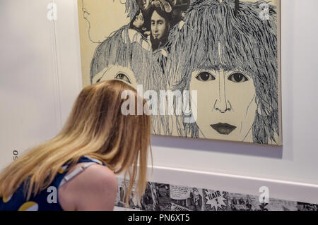 20 September 2018, Hamburg: A visitor to the Reeperbahn Festival sees in the exhibition: 'Klaus Voormann - It all starts in Hamburg' the album cover of the English band Beatles' album 'Revolver' by Voormann, known as the fifth Beatle. The music festival will take place from 19 to 22 September in the Hanseatic city. Photo: Axel Heimken/dpa Stock Photo