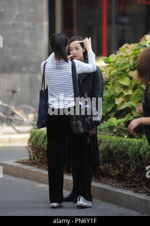 Milan, Victoria Song Qian in the center during a shooting Victoria Song Qian, the 31-year-old Chinese famous singer, actress, model and TV presenter, surprised walking through the streets of downtown during a shoot for a Chinese TV and South Korean. Here she is surrounded by bodyguard and many people of her staff walking in the quadrilateral of fashion this morning. Stock Photo