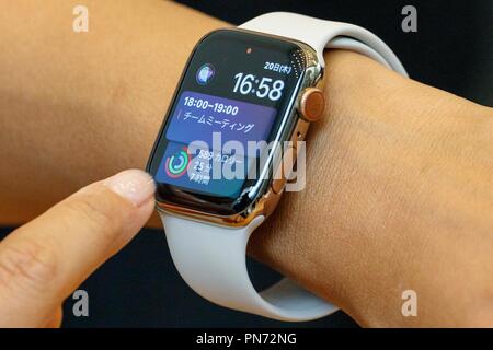 A woman tests a new iWatch Series 4 at the Apple Store in Omotesando on September 21 2018 Tokyo Japan. Apple fans lined up patiently in the early morning rain to get