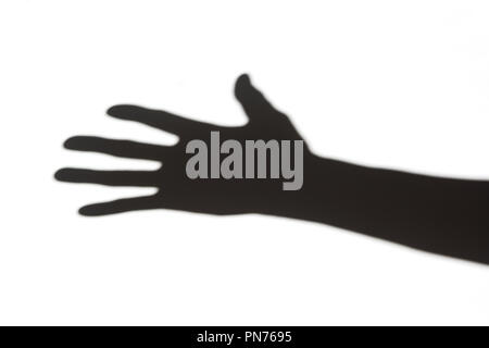 Shadow of a hand on white wall Stock Photo
