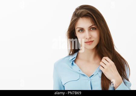 Feeling flirty. Beautiful young woman smiling and covering breasts with  hands while standing against grey background 13583566 Stock Photo at  Vecteezy