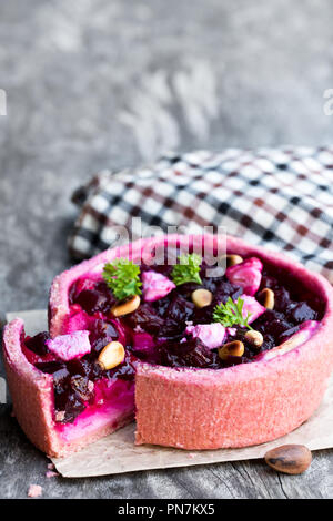 Homemade  balsamic beetroot and goat's cheese quiche on wooden table Stock Photo