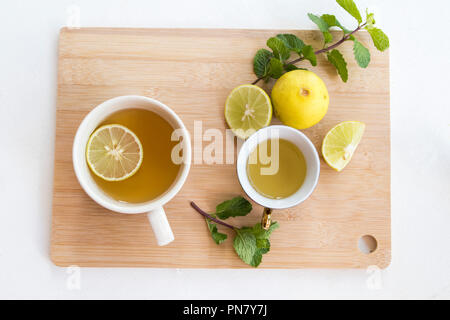 herbal healthy drinks hot mix honey lemon for health care with peppermint leaf and lemon slice on background wooden Stock Photo