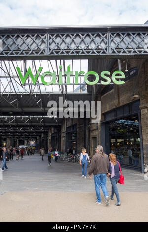 Waitrose store Kings Cross with people eating in outdoor seating area ...