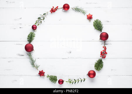 Christmas wreath made of fir branches, balls and eucalyptus on white background. Flat lay Stock Photo