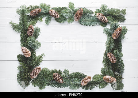 Christmas tree branches on wood background Stock Photo