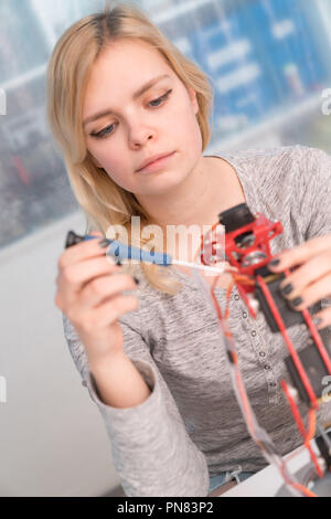 Young attractive female engineer working on robotics project Stock Photo