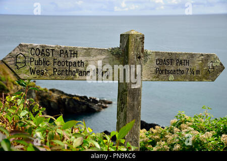 Coast Path wooden signpost outside the Cornish village of Portloe on the Roseland Peninsula, Cornwall, South West England, UK Stock Photo