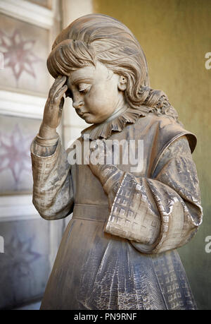 Picture and image  of the Realistic young grieving girl stone funary monument sculpture  commissioned by Enrico Amerigo for his sisters memory. beside Stock Photo