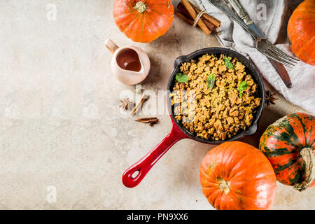 Homemade autumn pastries, pumpkin crumble pie in a cast-iron frying pan, light stone background, copy space top view Stock Photo