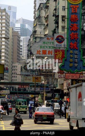 Taxi passing under the sign for the Beverly Hotel and others, Lockhart Road, Wan Chai, Hong Kong Stock Photo