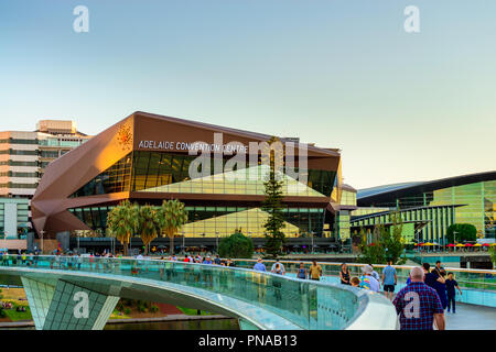 Adelaide, Australia - January 26, 2018: People walking on foot bridge over Torrens river in front of Adelaide Convention Centre Stock Photo