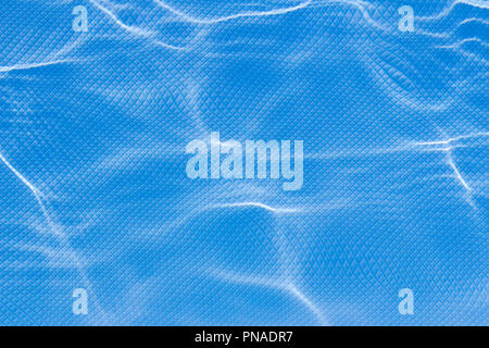 Refractive light distortions in wavy water, on a square shaped grid background Stock Photo